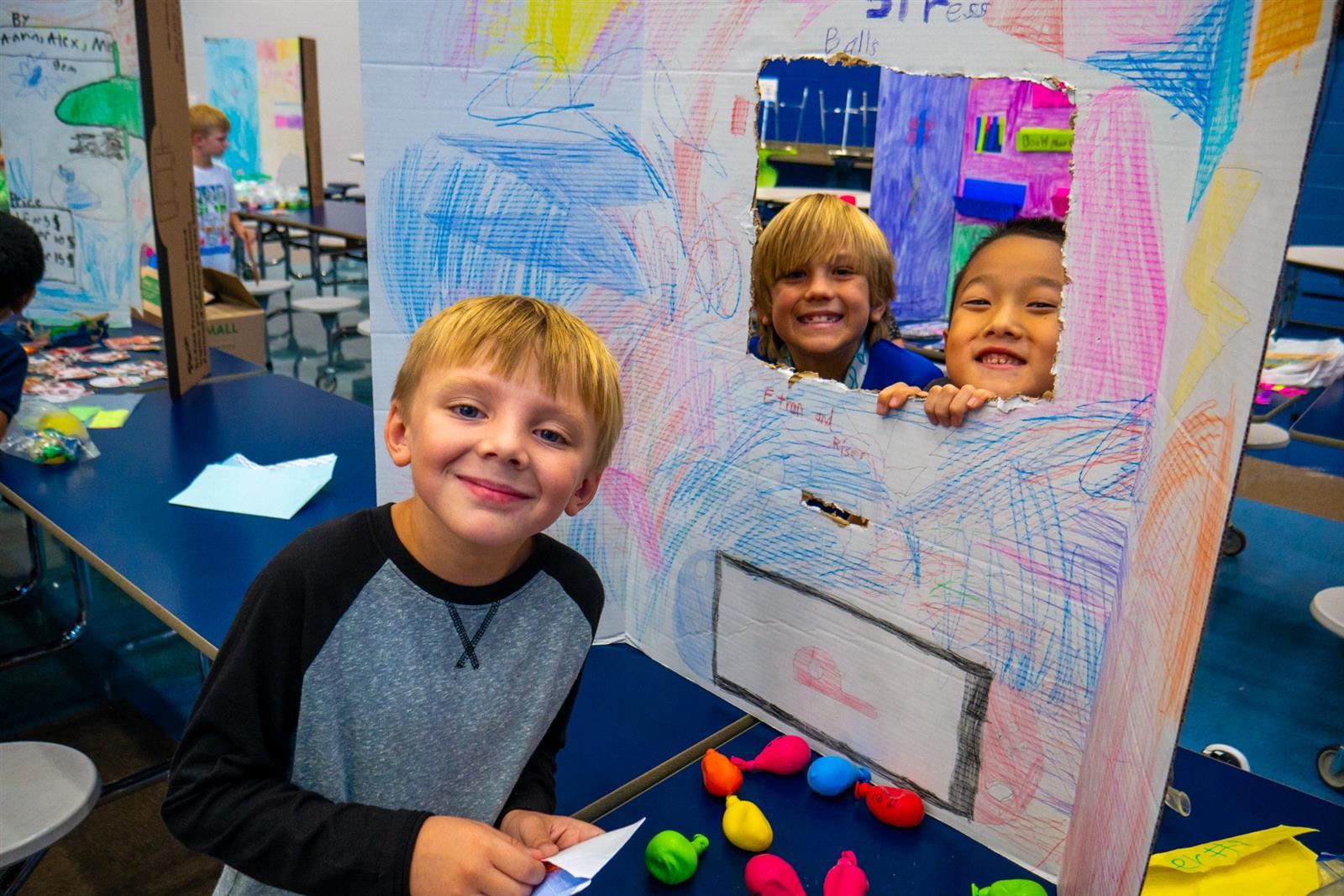three students and a posterboard